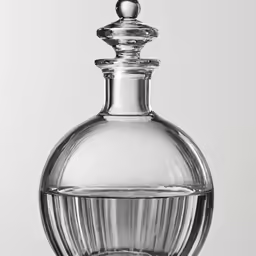 a clear vase with a metal top
