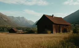 a farm with a mountain range behind it