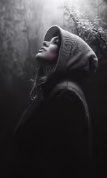 a woman wearing a gray hoodie looking up