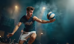 a young man in a blue shirt is playing volleyball