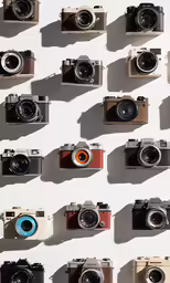 a wall that has many different types of cameras