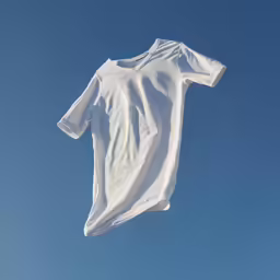 a white dress flying through the sky on top of a clothes line