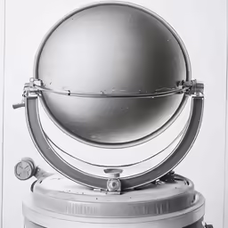 a black and white photo with a silver ball on top of it