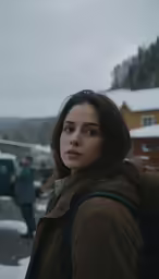 a woman standing in the snow with her head down