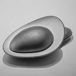 a silver object on the floor on a table