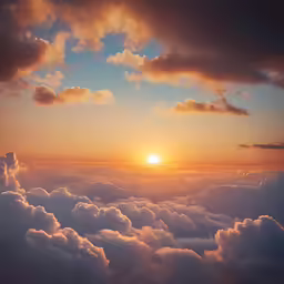the sun is shining above the clouds on the horizon