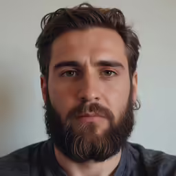 a man with long beard and grey shirt