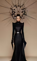 a beautiful lady wearing a black dress with long capes