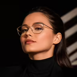 a close up of a person wearing glasses