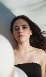 the woman is laying down with her hair in the air