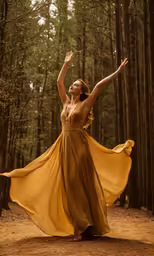a beautiful young woman dressed in a long brown dress dancing outside