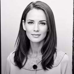 a black and white photo of a woman smiling