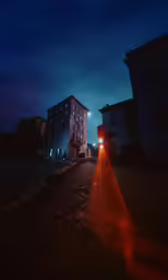 there is a long, narrow street that runs up to the tall building in the background