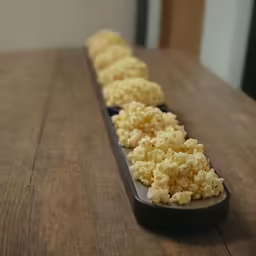 an image of scrambled eggs in black trays