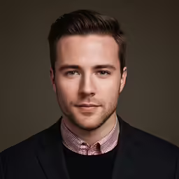 a man posing for the camera wearing a tie