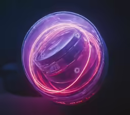 a spinning glass container is pictured against a black background