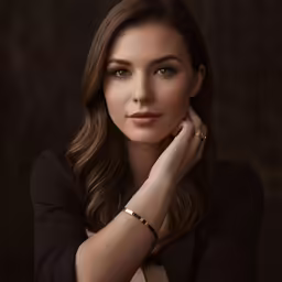 a beautiful young woman wearing a gold bracelet