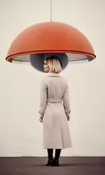 a woman standing under a large light fixture