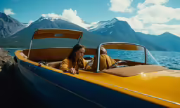 a woman is sitting in an old car while the view is clear
