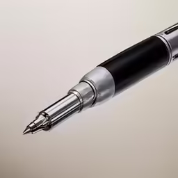 an ink pen in grey and black with a nill