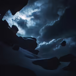 a group of rocks under some clouds with some rocks