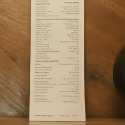 a receipt sits on a shelf next to a clock