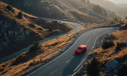 the red car is driving down a winding road