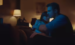 a man and woman sitting down next to each other