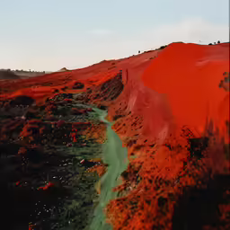 the sand at the hill is red and green