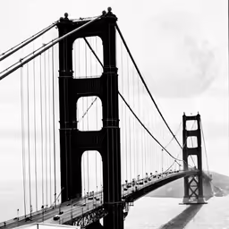 an artistic photo shows the golden gate bridge as a full moon sets