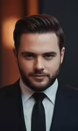 a man in a suit with a beard and hair styled