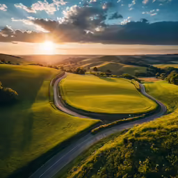 an aerial view of a winding road near some trees