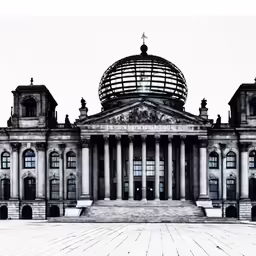 an old building with pillars and dome in the background