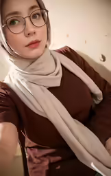 a girl wearing glasses and a scarf