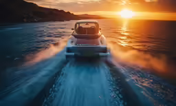 a car driving down the water at sunset