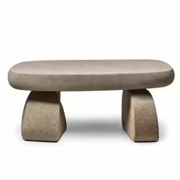 an outdoor bench with no legs and a rounded, concrete surface