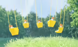 a group of people riding on yellow swings