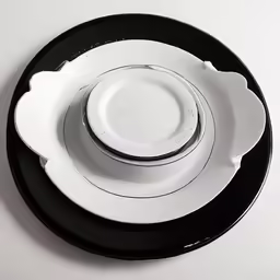 white and black dishes are sitting side by side on a plate