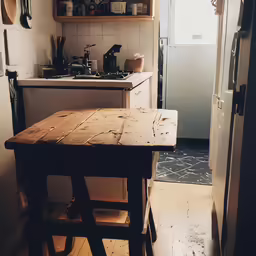 a kitchen with an old - fashioned wooden table in the middle