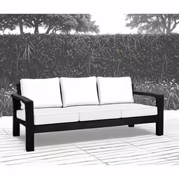a white and black sofa in front of a grass covered wall