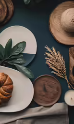 a table topped with plates and bowls next to a cup of coffee