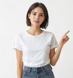 a woman in a white shirt and jeans holding her hand up