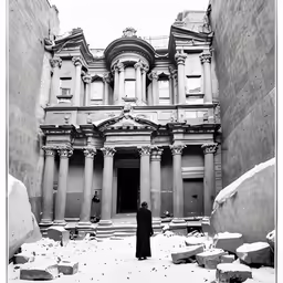 a person standing in front of a stone building