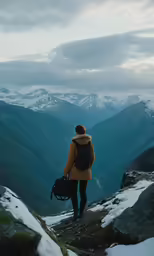 the person with backpack is walking on a mountain