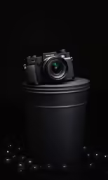 a camera is sitting on top of a trash can