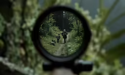 the back of a camera looking into a mirror at two people on a trail