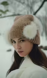 a woman wearing a hat in the snow