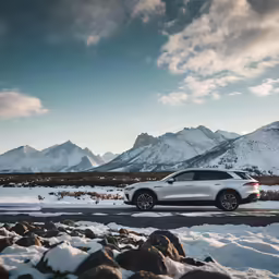 the car is parked at a snowy intersection