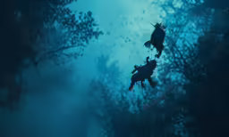 two divers are in the water surrounded by green trees