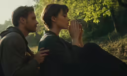 the actress is holding her hand up to her ear